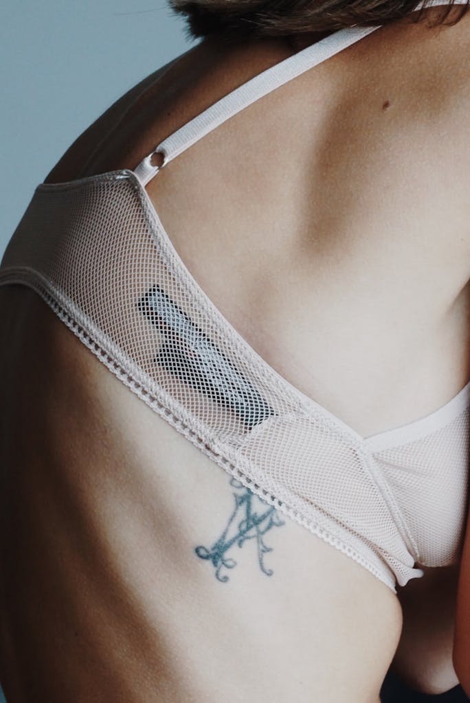 Woman in Sheer White Bra, with tags showing.